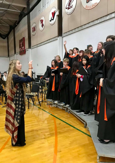 Ms. Lloyd conducting the HS in the National anthem.
