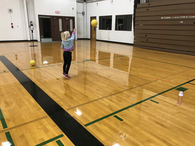 Elementary practicing serving for volleyball