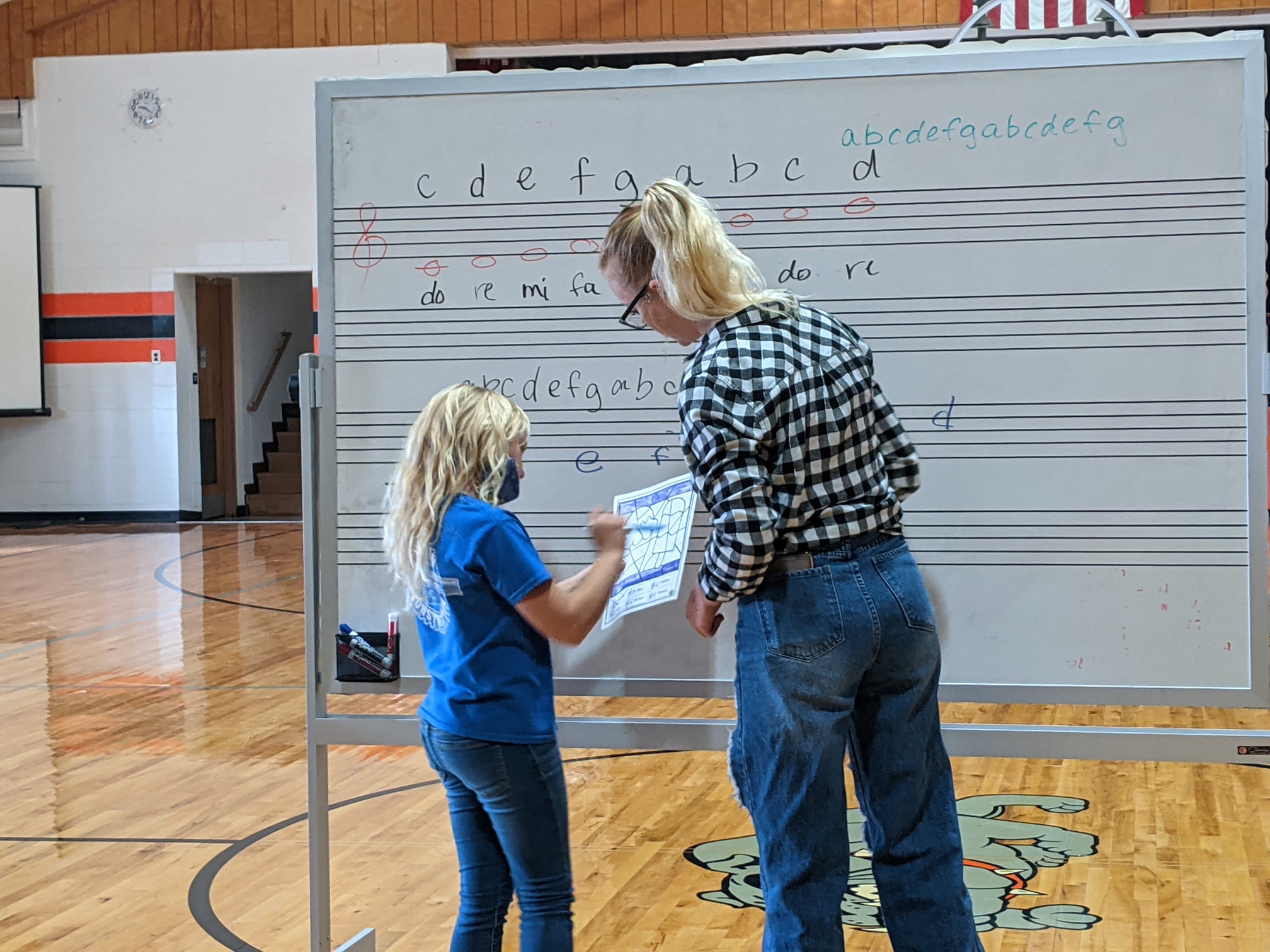 Our high school choir students helping 3rd grade learn their notes!