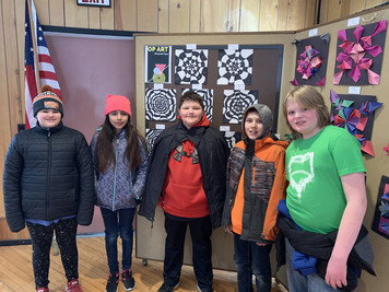 Students with their displayed art.